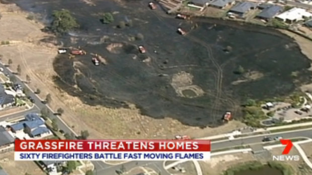 A grassfire damaged fences of 20 homes in Wallan on Saturday and is being treated as suspicious. Picture: Seven News.