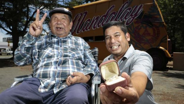 Mandalay Bus owners George Thaung and his son Stewart with a pair of opals given to them by a former homeless man, who had been helped by George before finding the gems at Lightning Ridge.