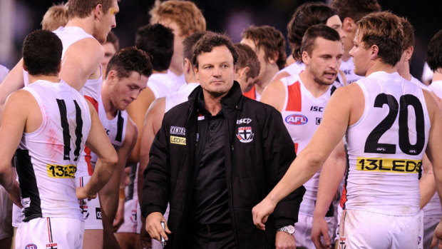 Scott Watters surrounded by St Kilda players during a game.