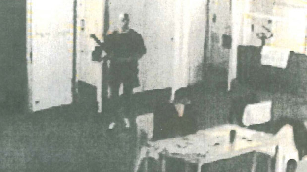 Prison CCTV footage released after Matthew Johnson's court case shows the convicted killer (left) sneaking up behind Carl Williams (seated) with the stem of an exercise bike before launching his deadly attack.