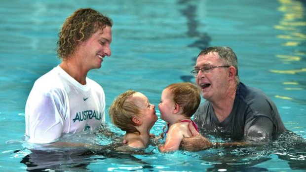 Swimmer Justin Norris with son Coda and Laurie Lawrence with grand-daughter Evie Reid.