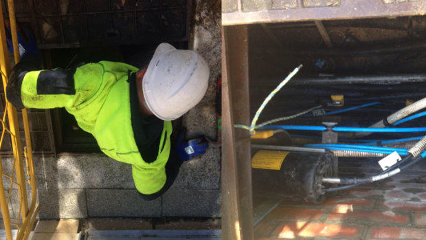 An NBN workers scrambles out of a 'spaghetti junction' in Perth's CBD.