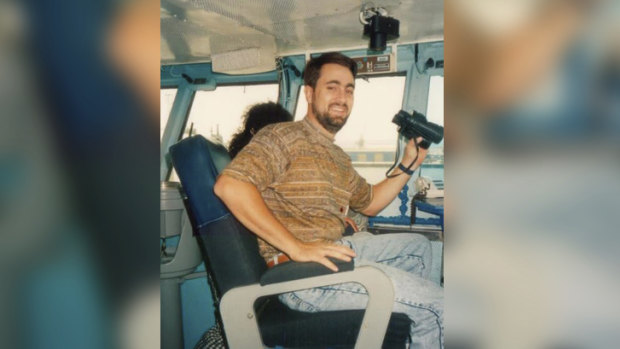 Mr Edwards sitting on a docked boat in Fremantle.