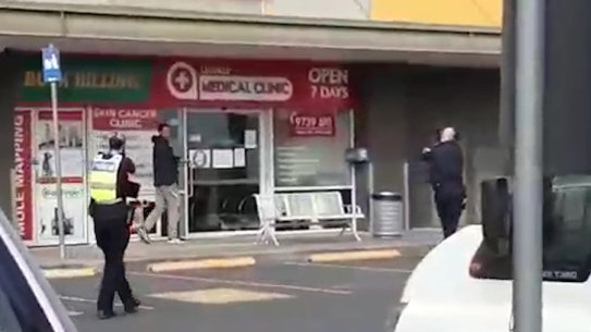 Police surround a man armed with a knife in Lilydale on Tuesday. 