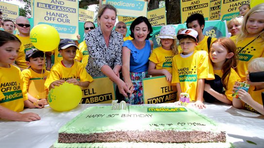 Griffith's Labor candidate Terri Butler and opposition health spokeswoman Catherine King cut a birthday cake to celebrate Medicare's 30th anniversary.