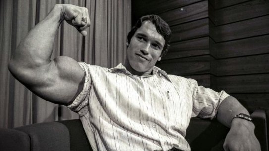 Arnold Schwarzenegger, who visited Sydney in 1974 as the reigning Mr Universe, flexes his muscles.