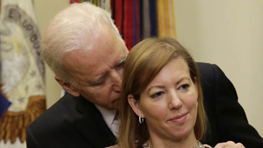 United States Vice President Joe Biden talks to Stephanie Carter (R) as her husband Ash Carter (not pictured) delivers his acceptance speech as the new Secretary of Defense at the White House in Washington February 17, 2015. Carter served as the deputy defense secretary, the department's number two position, from 2011 to 2013.    REUTERS/Gary Cameron   (UNITED STATES - Tags: POLITICS MILITARY)