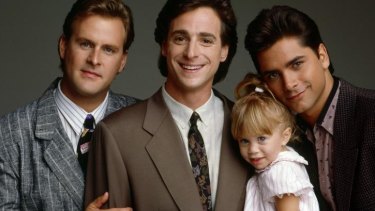 The cast of family comedy Full House: Dave Coulier, Bob Saget, John Stamos and one of the Olsen twins.
