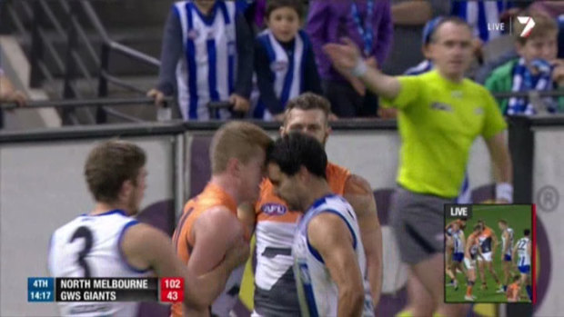 Lindsay Thomas, playing for North Melbourne in 2013, leans into his GWS opponent Jacob Townsend.