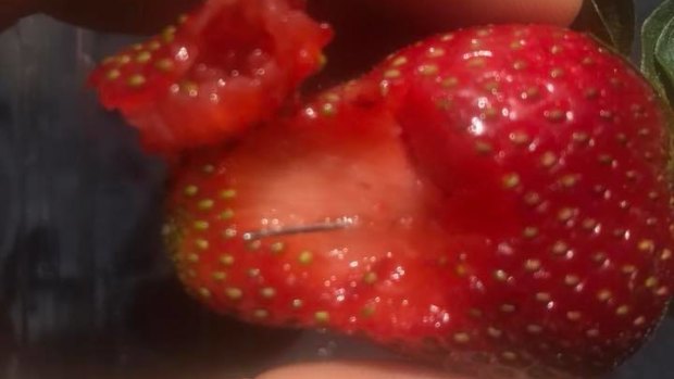 A Queensland man posted this photo of a strawberry with a needle in it after reporting his friend swallowed one. 