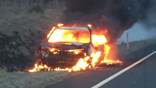A car sits ablaze on the Monaro Highway near Michelago after hitting a kangaroo on Monday morning.