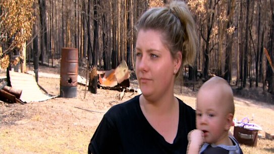 Mogo resident Melinda Evans, with son Michael, said she had been told by four Centrelink workers she was "not in the area [affected by bushfires]".