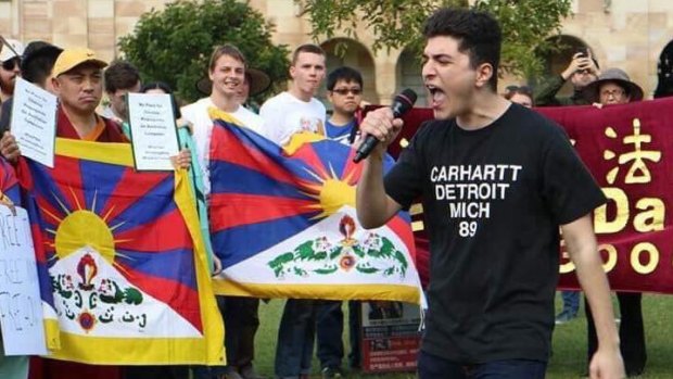 Activist Drew Pavlou speaks at a protest at UQ.