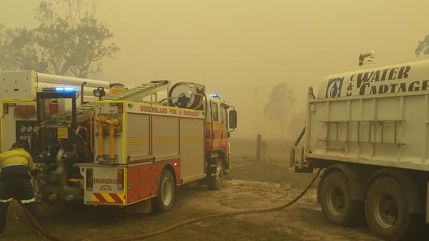 Firefighters position themselves to attempt to control the blaze.