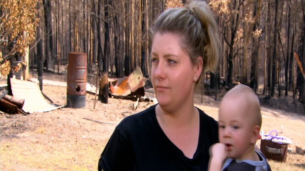 Mogo resident Melinda Evans, with son Michael, said she had been told by four Centrelink workers she was "not in the area [affected by bushfires]".