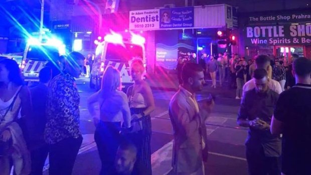 Patrons and emergency services outside Prahran's Love Machine club. 