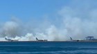 A grassfire broke out at Sydney Airport after reports of an explosion on a plane.
