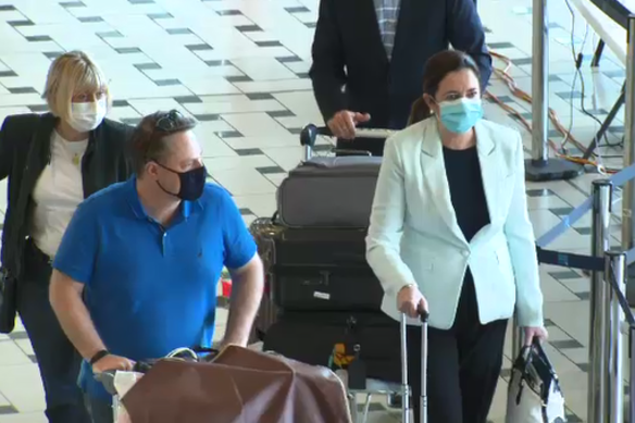 Premier Annastacia Palaszczuk and Brisbane lord mayor Adrian Schrinner arrive at Brisbane Airport on Sunday.