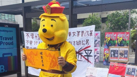 Chinese international student Aaron dressed as Winnie the Pooh as part of his protest against Chinese president Xi Jinping at a bus stop outside the entrance to the University of Sydney in February 2023.