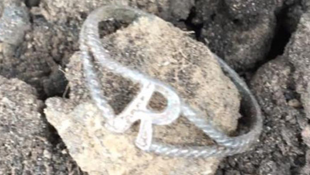 The silver ring with the letter 'R' on it was found in a paddock. 