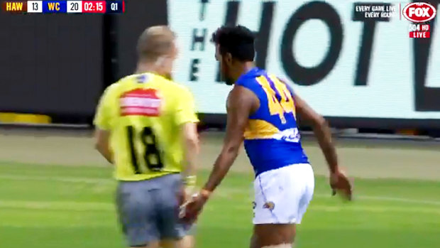 Cheeky: West Coast forward Willie Rioli is likely to come under scrutiny for this innocent bum tap on umpire Ray Chamberlain at Etihad Stadium on Sunday.