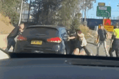 A man has allegedly carjacked a woman on a busy motorway in Sydney’s west with two kids in tow.