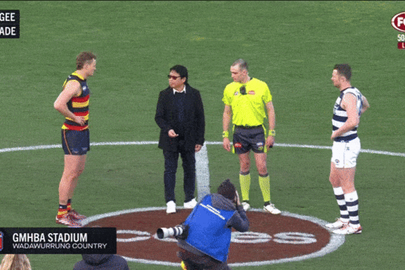 Nguyen tosses the coin before a Geelong-Adelaide AFL game in August.
