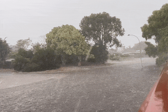 The flash flooding in a street in Clarkson, north of Perth.