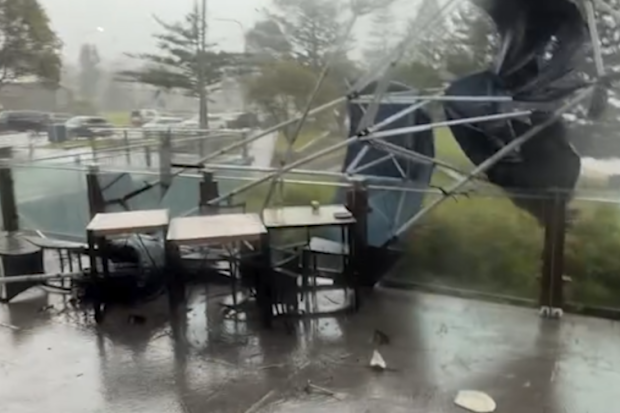 Footage shared on social media showed tables and chairs outside cafés in Ulladulla being swept down the street as winds reached gusts of 100km/h as a mini tornado hit.
