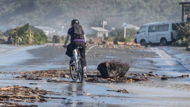 Huge waves at high tide have caused damage and left large debris on the Esplanade between Island and Owhiro Bays, Wellington.