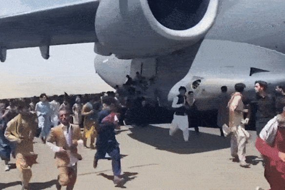 Some men were seen climbing onto the landing of a military plane as it took off on Monday, and at least two fell to their deaths. 