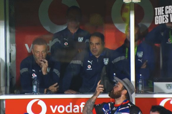 New Zealand Warriors fan Calley Gibbons does a shoey in front of coach Stacey Jones.