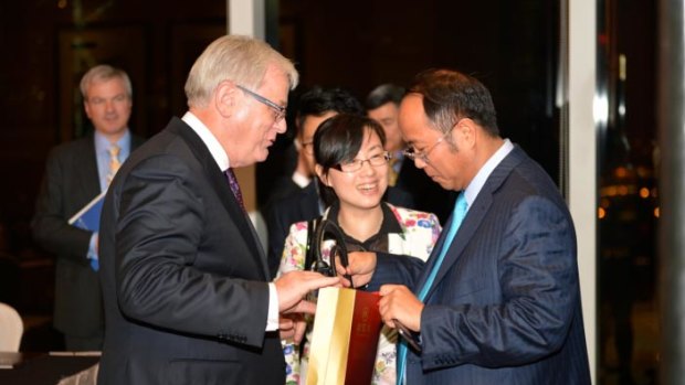 Huang with then Trade Minister Andrew Robb in Hong Kong in 2014.
