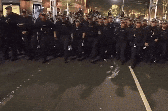 Police charge at demonstrators during the Town Hall protest.