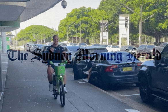 Roosters halfback Daly Cherry-Evans cruises along Driver Avenue on an e-bike before Christmas.