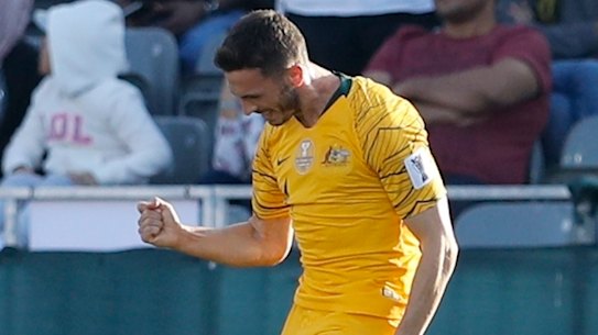 Happy days: Apostolos Giannou celebrates after scoring Australia's third goal against Palestine.