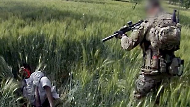 A still from a video shows an Australian soldier allegedly about to shoot a subdued Afghan man in 2012.