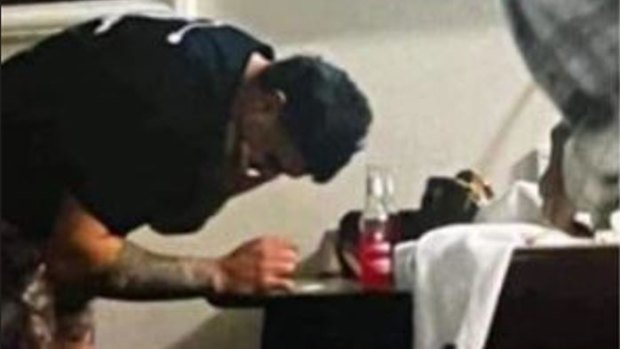 Latrell Mitchell appearing to lean over a table with a white substance on it. There is no suggestion the substance is an illicit drug.