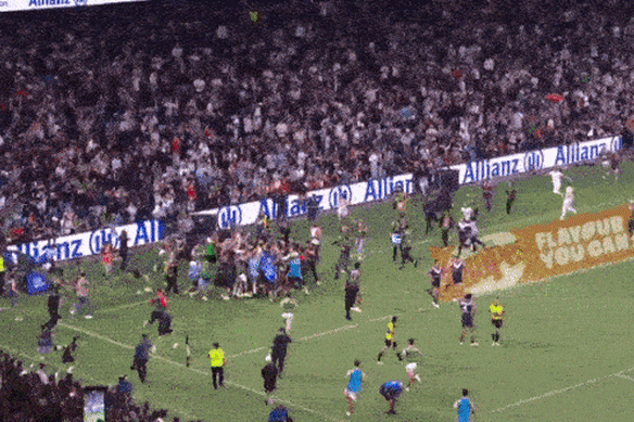 The crowd rushes the field at Allianz Stadium.