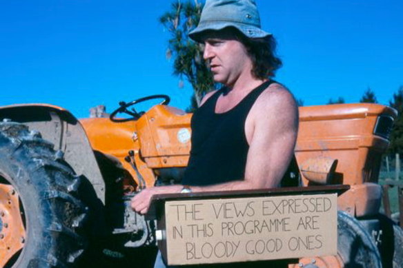 John Clarke as Fred Dagg, a caricature of a New Zealand sheep farmer that became so successful Clarke left the country partly to escape it.