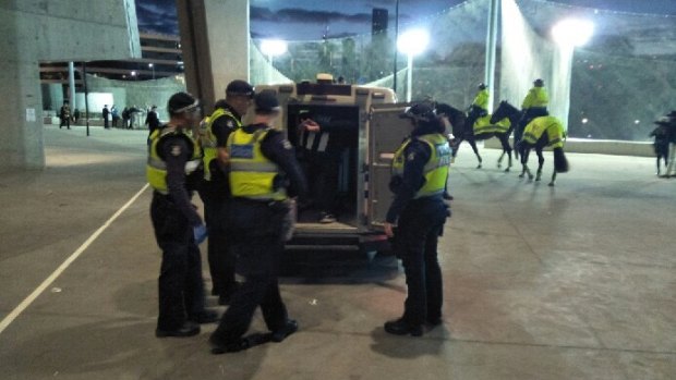 A Collingwood supporter is arrested at the MCG after the game.