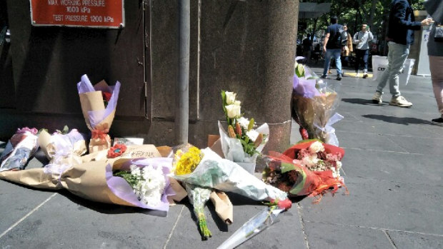 The number of floral tributes left in Bourke Street on Saturday grew as the day wore on.