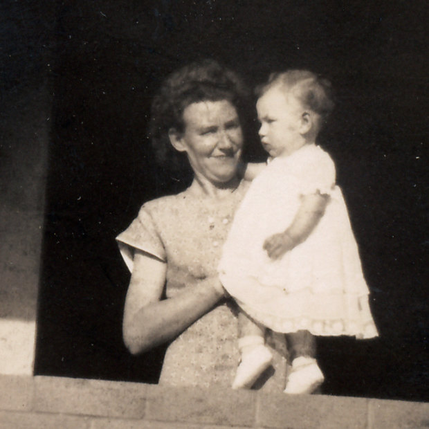 The author’s mother, holding toddler Christine, at their completed home. 