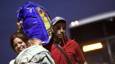 A Venezuelan couple prepares to board a plane bound for Sao Paulo in Boa Vista. Several Brazilian states have agreed to take migrants to ease the pressure on the Venezuelan border.
