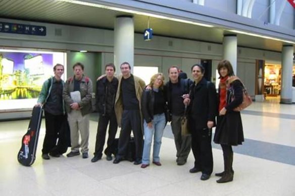 Touring in 2004, from left: Bruce Dessner, Philip Glass, David Cossin, Andy Cotton, Lisa Moore, Evan Ziporyn, Michael Gordon and Wendy Sutter.