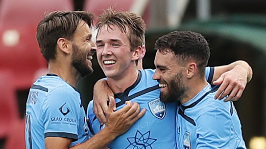 Calem Nieuwenhof celebrates his maiden A-League goal with Milos Ninkovic and Anthony Caceres.