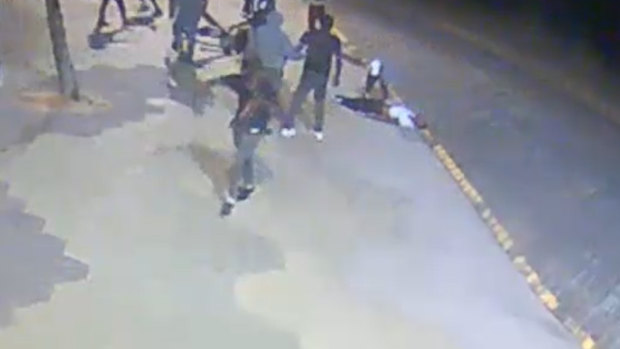 An image showing the man being robbed after he was bashed unconscious.