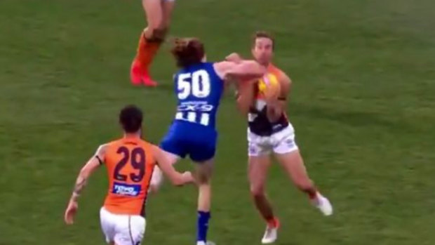 North Melbourne's Ben Brown was reported for this elbow on Giants defender Matt Buntine.