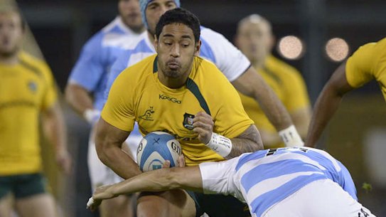 Wallabies winger Joe Tomane is tackled by Juan Hernandez.