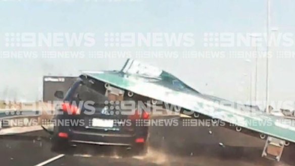 Sign fall: Tullamarine Freeway sign falls and crushes car, injuring woman